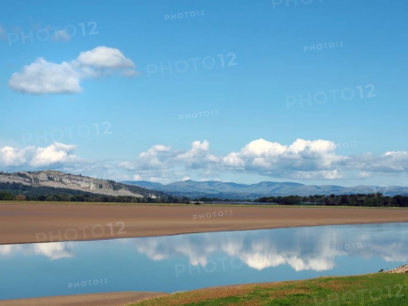 View of the river kent near arnside and sandside in cumbria with surrounding lakeland hills