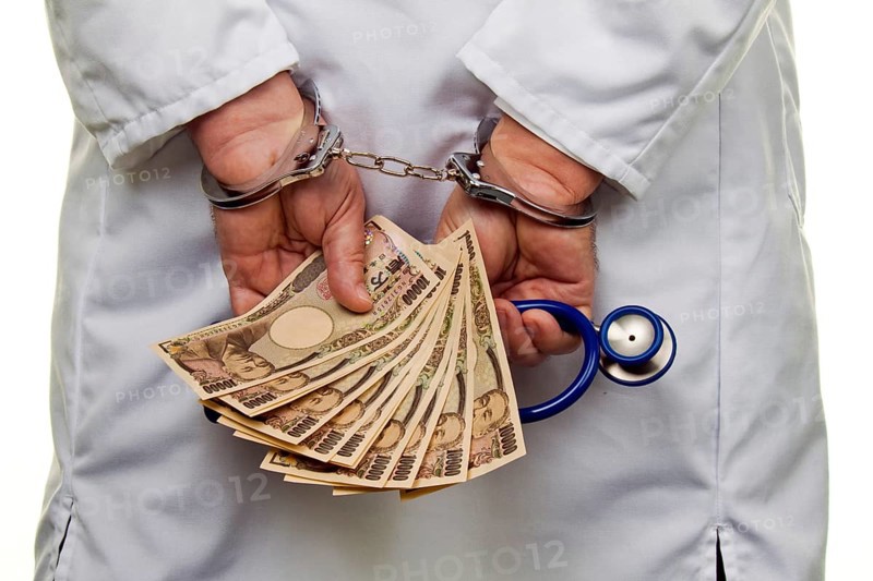 A doctor with Japanese YEN banknotes and handcuffs Austria