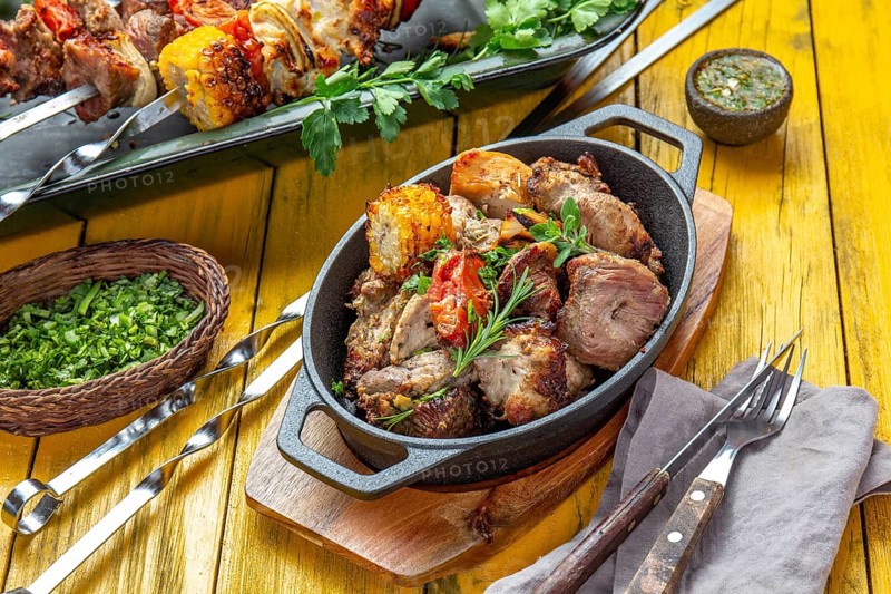 Food, Food, Bbq grilled meat, pork, chicken and vegetable on cast iron pan. Grilled skewers on yellow wooden background. Top view