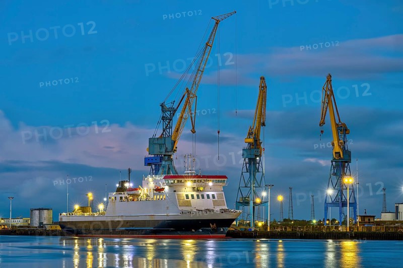 Three yellow and blue cranes at dusk in the harbour of Belfast, Northern Ireland