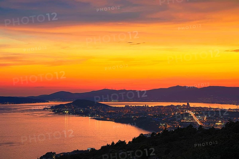 View of a city at dusk with vivid colours in the sky and reflecting water, Split, Dalmatia, Croatia, Europe