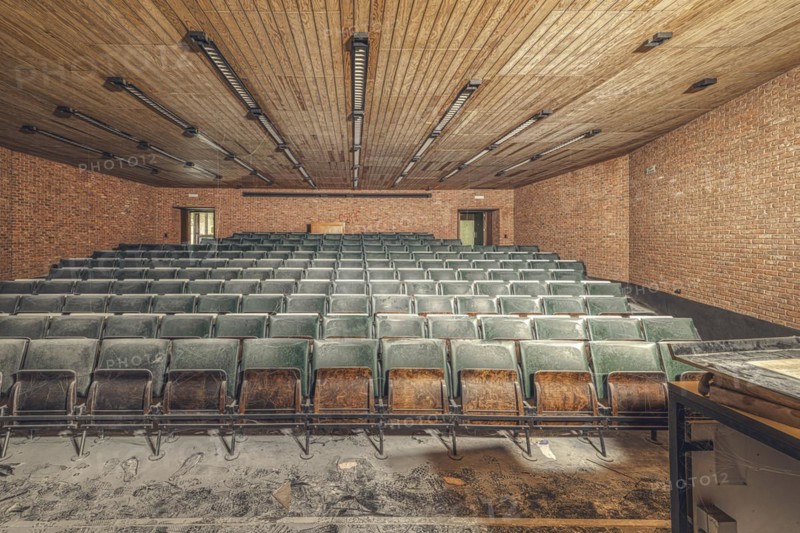 Dusty, empty lecture theatre with green rows of seats and visible bricks, Institute of Molecular Biology, Lost Place, Sint-Genesius-Rode, Province of Flemish Brabant, Belgium, Europe