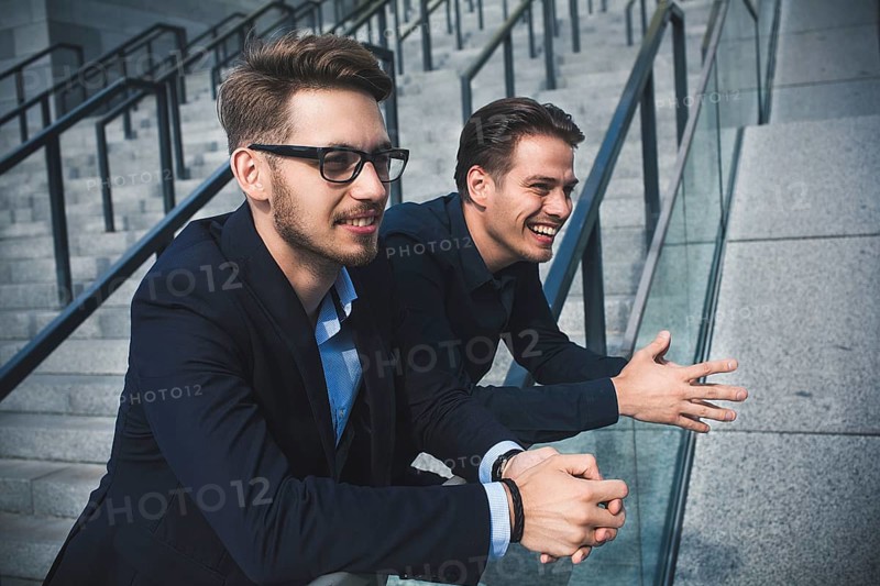 Two awesome businessman have a rest between a work. Speak easy