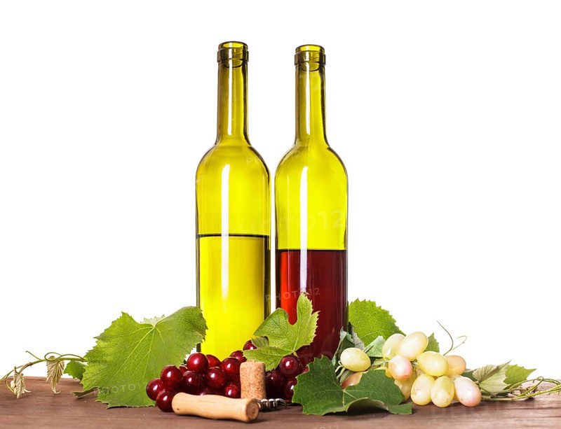 Red and white wine in bottles on the wooden table