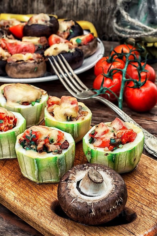 Easy appetiser of courgette stuffed with cheese, garlic and tomatoes.Photo tinted.Selective focus