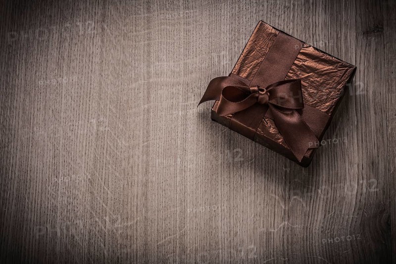 Present boxed in glittery crumpled paper with bow celebration concept