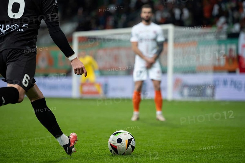 LUBIN, POLAND - MARCH 1, 2025: Football match between KGHM Zaglebie Lubin vs Piast Gliwice. One player kicks the ball opponent player in the wall