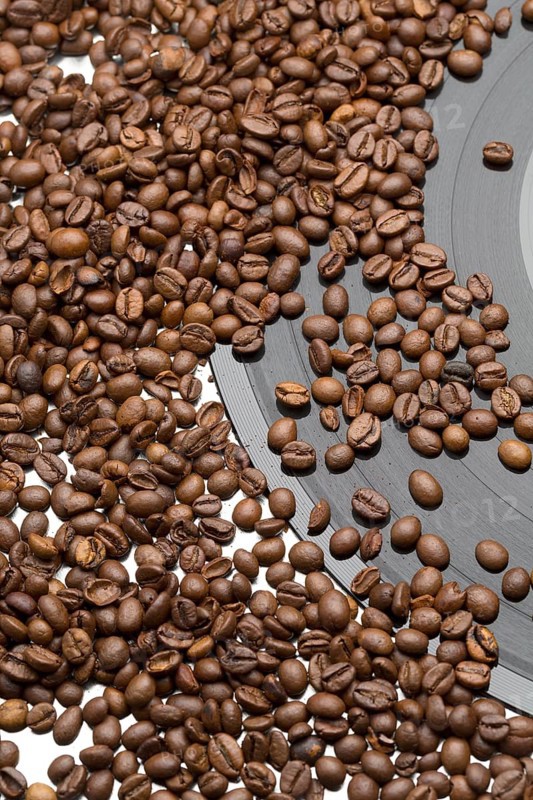 Coffee beans and vintage vinyl record on white background