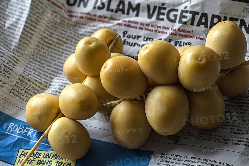 Fresh dates from French vegetables market on newspaper