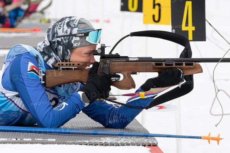 Sportswoman biathlete Arina Soldatova Kamchatka Krai rifle shooting prone position. Biathlete in shooting range. Open regional youth biathlon competitions East Cup. Kamchatka, Russia, Apr 12, 2019, Europe