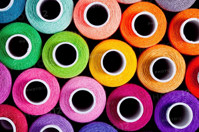 Sewing threads as a multicolored background close up