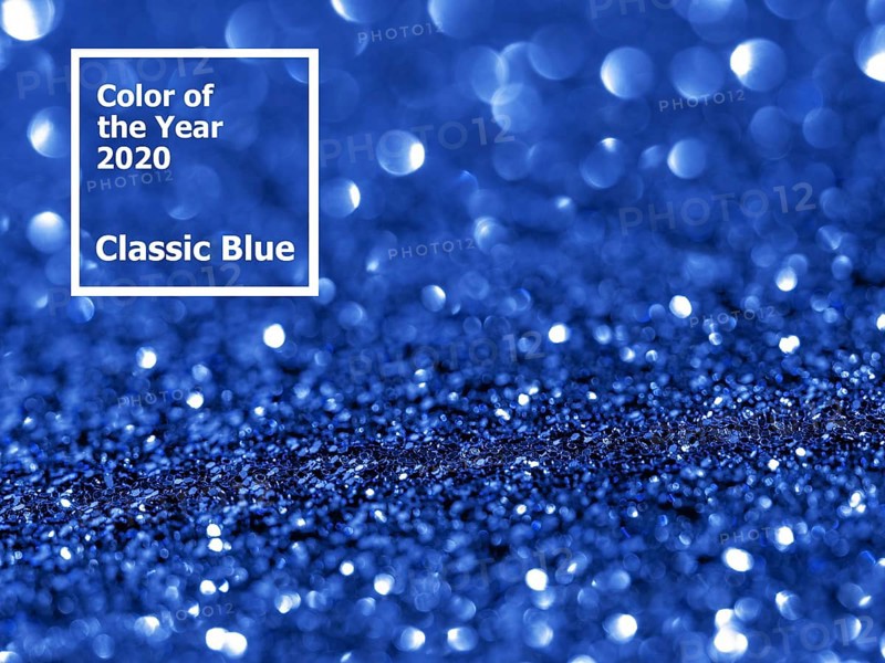 Sparkling background with bokeh made of Classic Blue 2020 color. Color of year 2020 blurred backdrop for holidays and parties. COY2020 Classic Blue concept. Copy space for text
