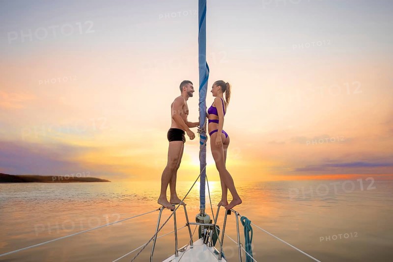 Romantic date on the yacht. Love story. Romantic walk on the yacht on sunset background. Guy and girl on the yacht