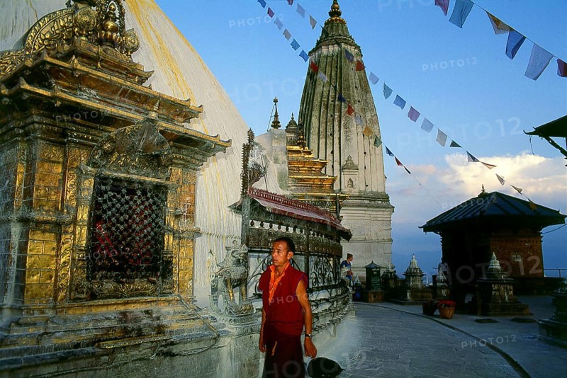 The date of construction of the Svayambhunath stupa, its origins steeped in myth, is unknown. According to the inscriptions on an ancient and damaged stone tablet at Svayambhunath, King Vrishadeva (ca. 400 CE) was the first to build a place of worship on the site. His grandson, King Manadeva I (ca. 464-505) may have made some additions.<br/><br/> The Muslim invasion of 1349 undid all the pious building work, the marauding Muslim warriors dismantling every kafir (infidel) sanctuary that they came across. An inscription at Svayambhunath records the date of the Muslim invasion as 20 November 1349, in all probability a very accurate account. After the raids Svayambhunath was restored, and most of the buildings seen today are from the post-invasion period.<br/><br/> Swayambhunath (Devnagari: ??????????? ?????) is an ancient religious complex atop a hill in the Kathmandu Valley, west of Kathmandu city. It is also known as the Monkey Temple as there are holy monkeys living in parts of the tem...