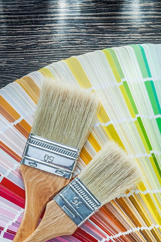 Color pantone fan paint brushes on wooden board top view