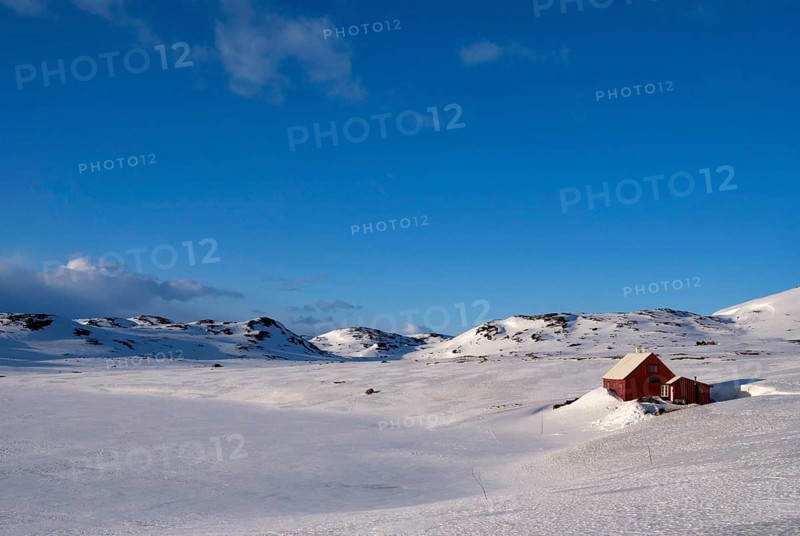 Wooden house on the snowcovered Norwegian mountain plateau Hardangervidda