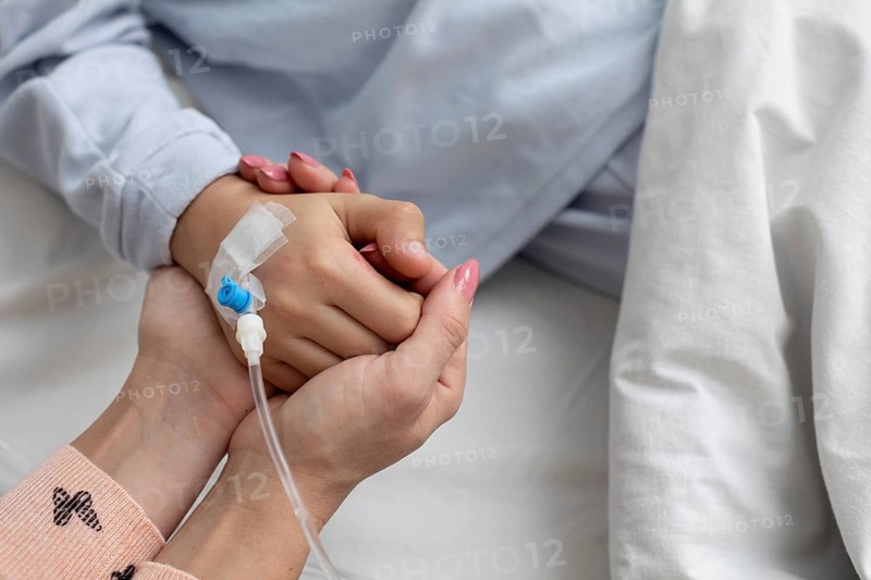A deeply touching moment of support and emotional connection shared in the comforting atmosphere of a hospital setting