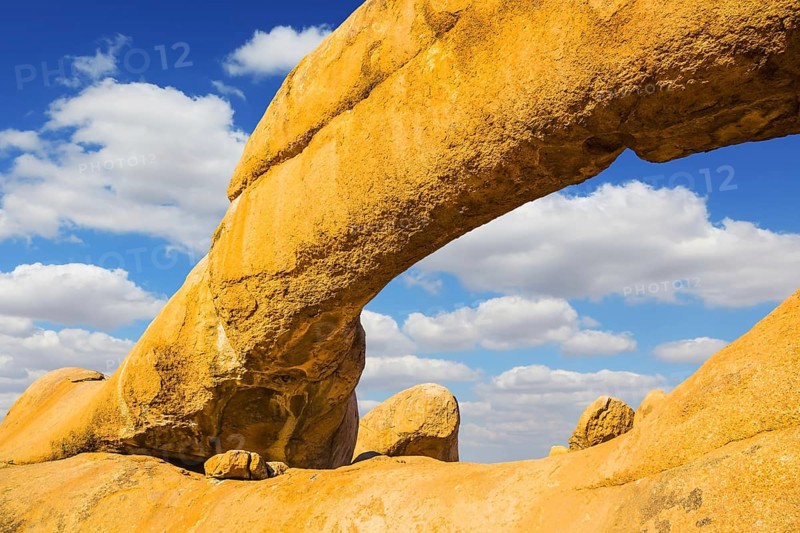 The natural massif of smooth bald granites among the Namib Desert. Stone arch of Spitzkoppe, Namibia. Concept of extreme and ecological tourism