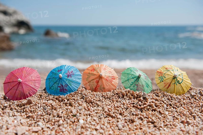 Colorful Chinese paper parasols for shade at the sunny beach