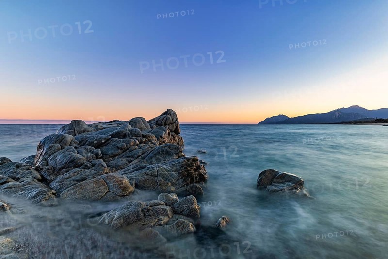 Rocks in the sea on the beach of Torre di Bari at sunset, long exposure, Torre di Bari, Bari Sardo, Ogliastra, Sardinia, Italy, Europe