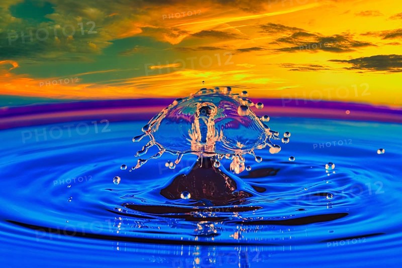 A drop of water in the middle of a lake with a colourful sunset in the background, highspeed photography, drop photography, composing, Grenzach- Wyhlen, Baden-Württemberg, Germany, Europe