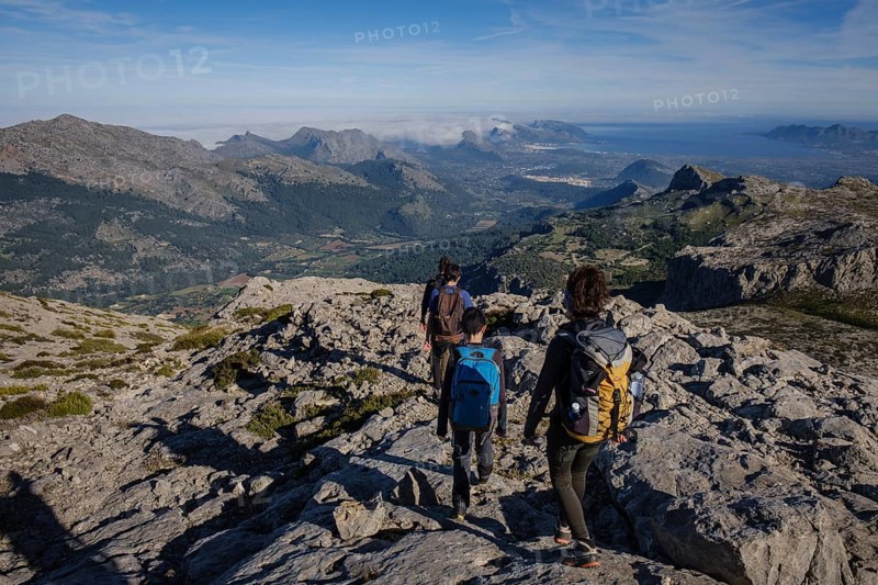Hikers descending the Puig Tomir towards Fartaritx, Majorca, Balearic Islands, Spain, Europe