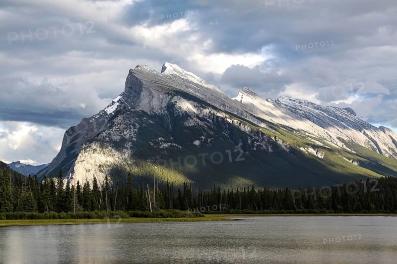 Well-known mountain by the sea rises strikingly into the cloudy sky
