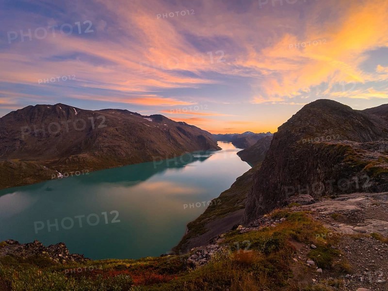 Gjende Lake, Colorful Sky and Mountains at Sunset. Jotunheimen National Park. Norway