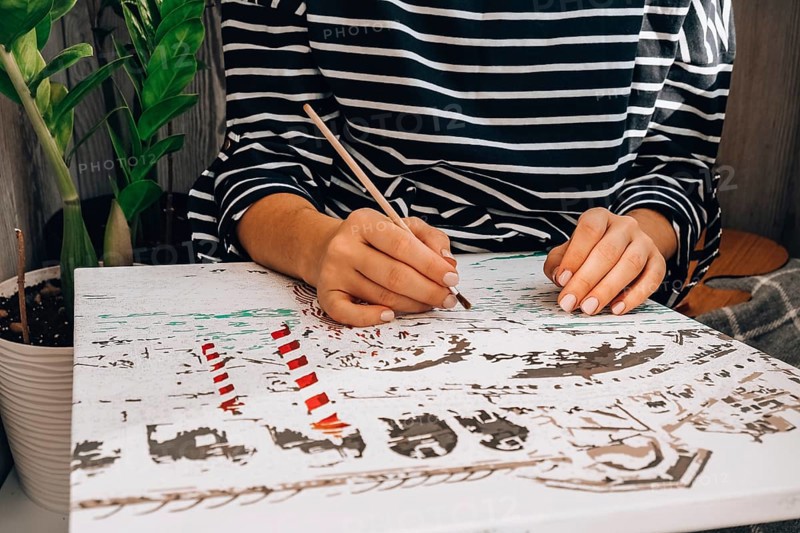 Female hands coloring canvas Picture by numbers Creative hobby. Painting for beginners. Leisure activity for stay home lockdown, anti-stress idea. Meditation, relax concept. Mindfulness acivity