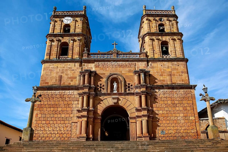 Front view of impressive colonial Cathedral of the Immaculate Conception against blue sky and veil clouds, Barichara, Colombia, South America