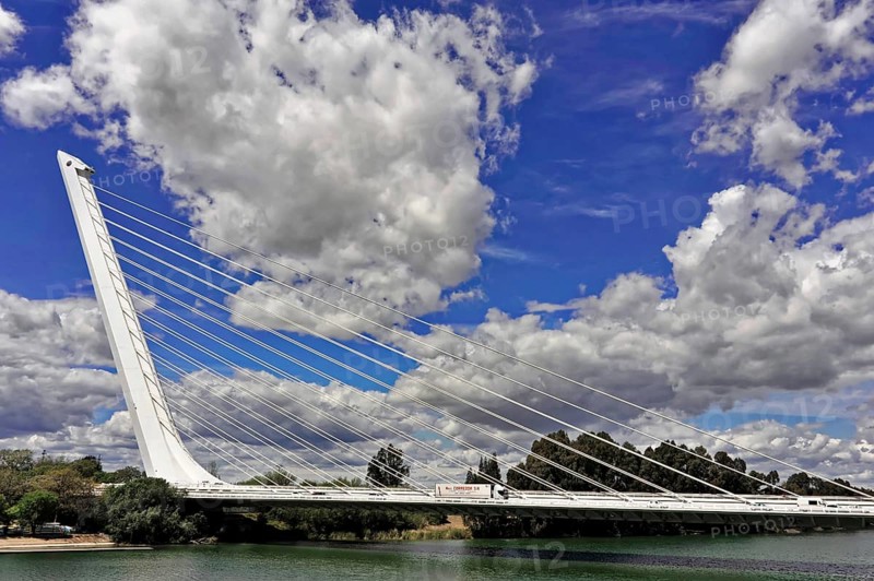 Puente del Alamillo, Alamillo Bridge, over the Guadalquivir River, built as part of the infrastructure improvements for Expo 92, Seville, Spain, Andalusia, Europe, cable-stayed bridge over river in front of a sky with clouds, Europe