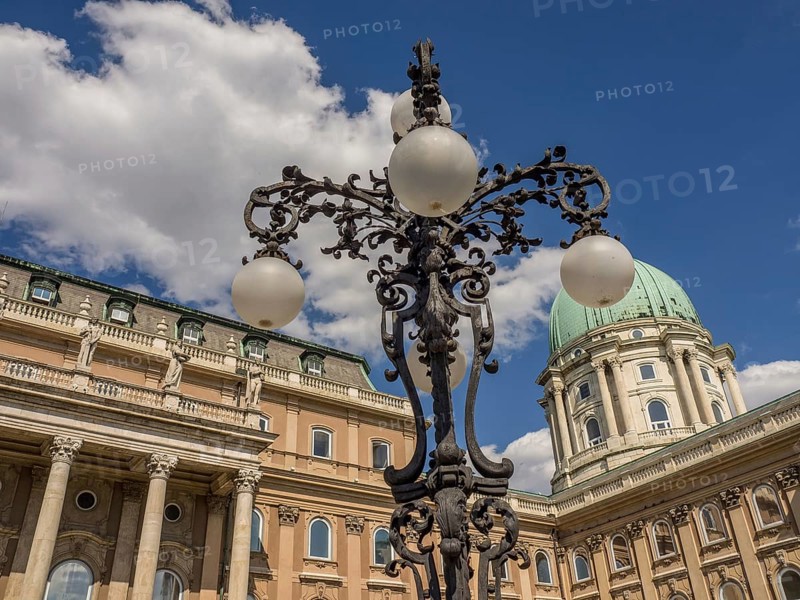 Historic lantern and building with green dome in Budapest under a cloudy sky, budapest, danube, hungary