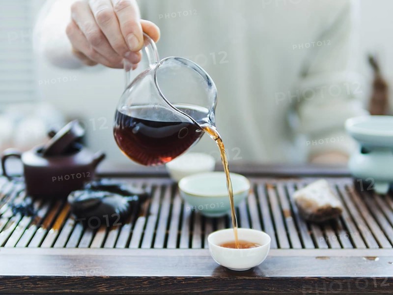 Chinese tea ceremony. Master pouring puer tea in cups. Pu erh tea ceremony