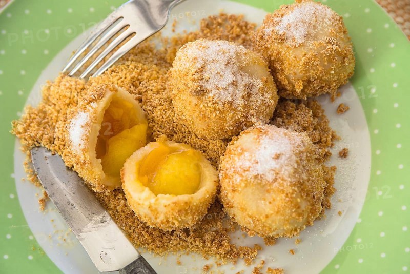 Real apricot dumplings with breadcrumbs and sugar on a plate - fruit dumplings