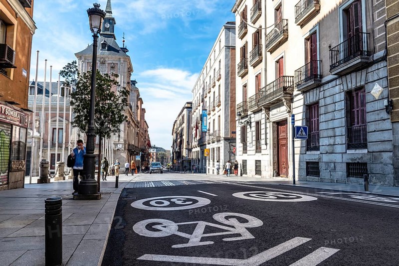 Madrid, Spain, November 1, 2020: Mixed traffic lane for bicycles and cars with a maximum limit of 30 kilometers per hour painted on the asphalt. Central Madrid. Mayor Street, Europe