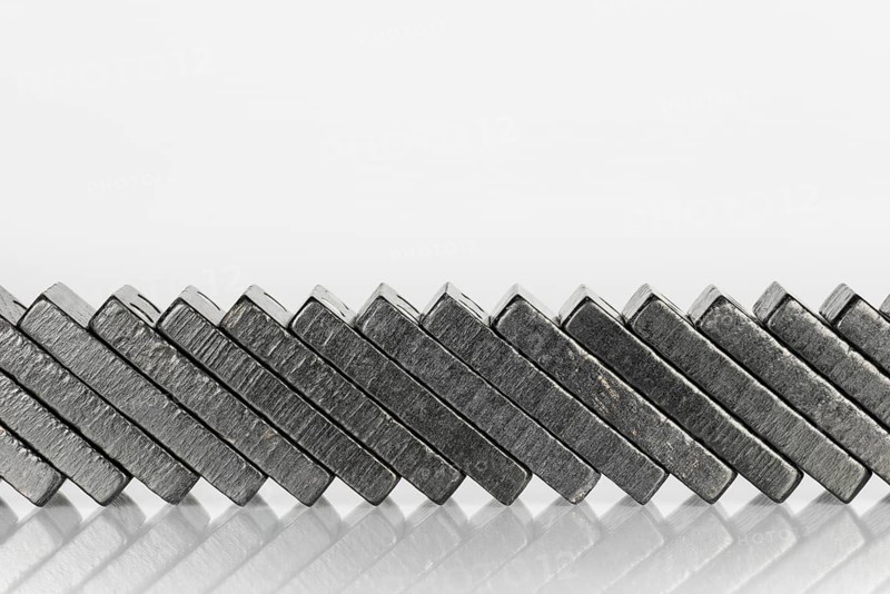 Composition of lying black domino bricks with white dots