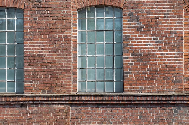 Three large mullioned windows in a uniform brick wall, Bottrop, North Rhine-Westphalia, Germany, Europe