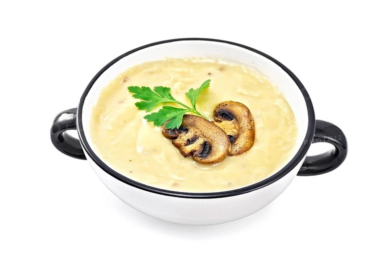 Soup puree with champignons in the bowl isolated on white background