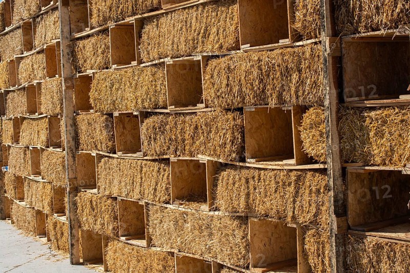 Harvesting in agriculture bales of hay are stacked in large stacks