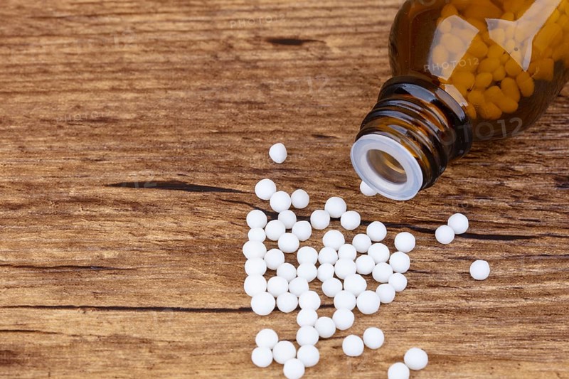 Homeopathy medicine on wooden background