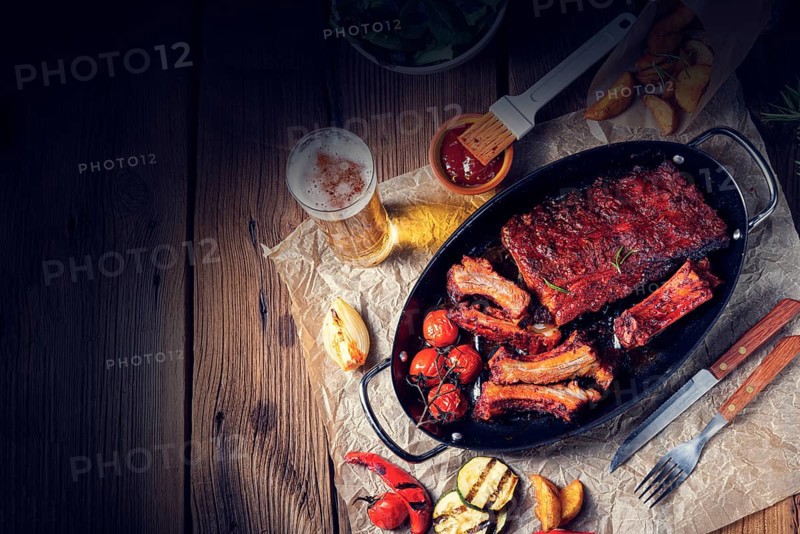 Grilled ribs in a spicy marinade with salad and vegetables