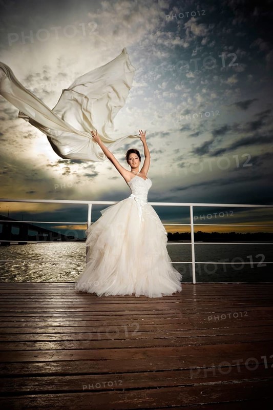 Pretty lady in a wedding dress on deck