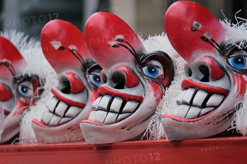 Clown masks with large teeth and blue eye accent, cheerful and scary impression