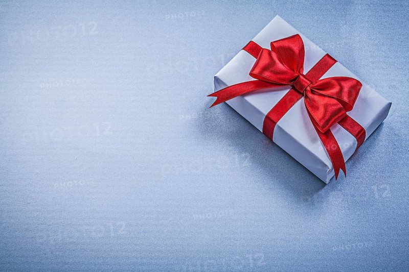 Present with ribbon on blue background holidays concept
