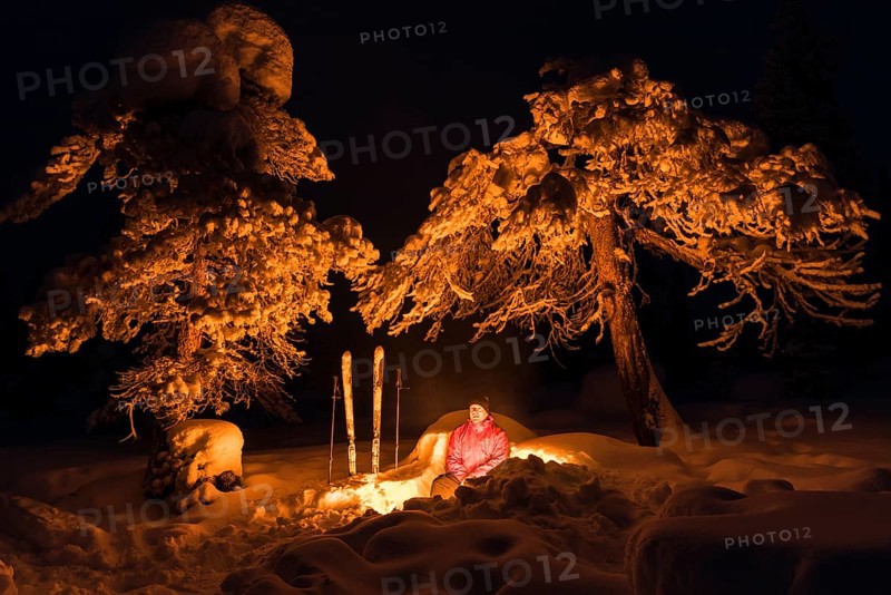 Man around a campfire, Norrbotten, Lapland, Sweden, February 2016, Europe