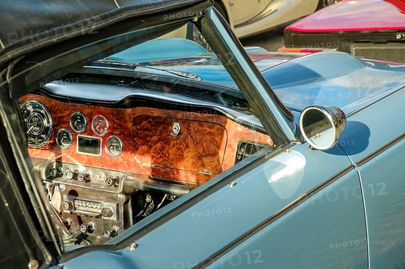 Lisbon, Portugal, Jan 20, 2024: Car design details, interior of vintage car in leather and wood, authentic front panel, glove box, meters and radio, Europe