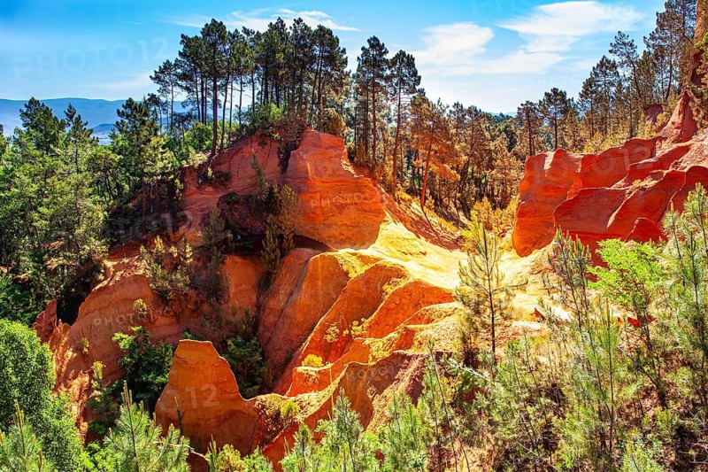 France, Provence. The village of Roussillon is surrounded by picturesque ocher cliffs. Now the rocks have grown into dense forests. Bizarre ocher rocks, Europe