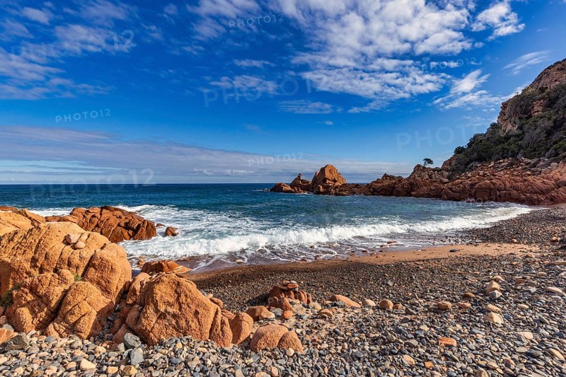 Coastal landscape with red rocks and surf in blue sky and sunshine, Spiaggia di Cala E'Luas, Ogliastra, Sardinia, Italy, Europe