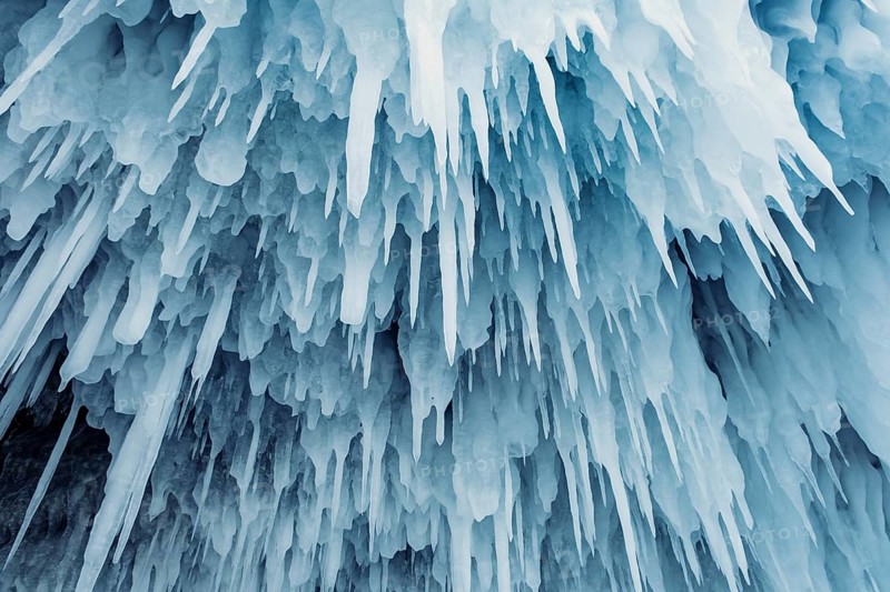 Ice cave on Baikal lake in winter. Blue ice and icicles in grotto. Olkhon island, Baikal, Siberia