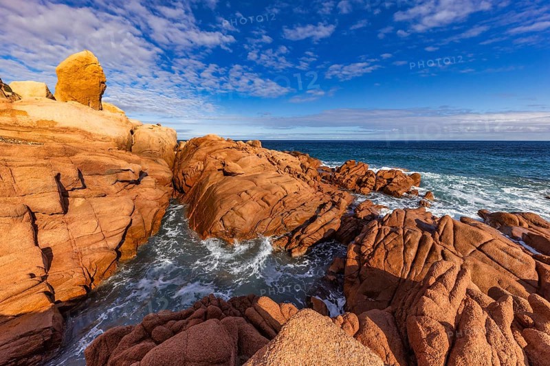 Coastal landscape with red rocks and surf in blue sky and sunshine, Spiaggia di Cala E'Luas, Ogliastra, Sardinia, Italy, Europe